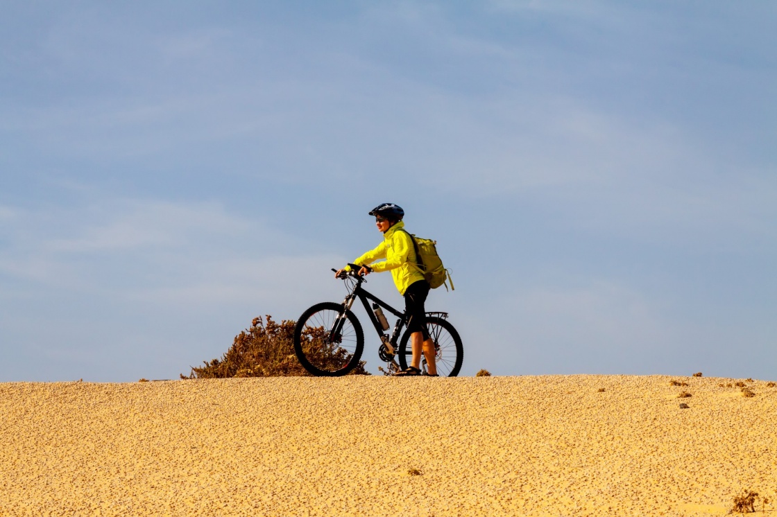 woman in yellow riding bike on on Canary island